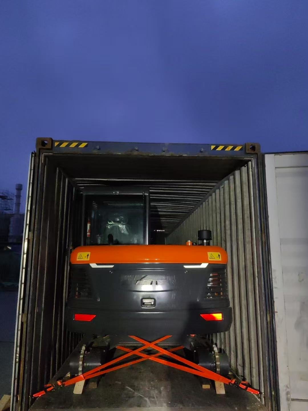 Excavator positioned inside a container with crossed securing straps for YIHUI's Guyana shipment