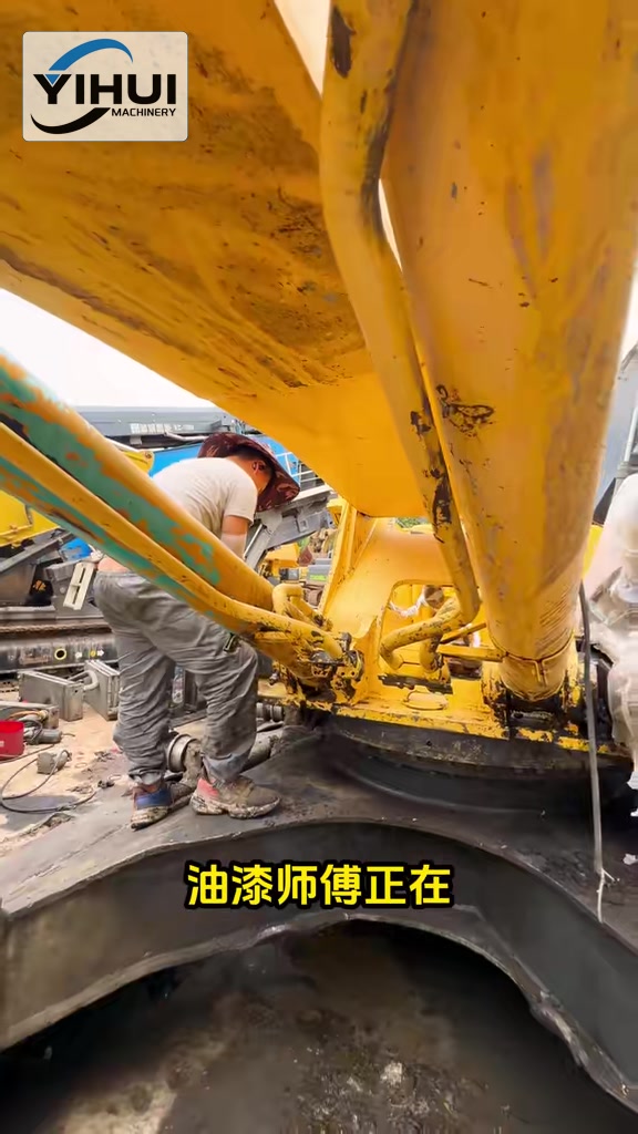 Technician preparing surfaces inside the excavator upper structure